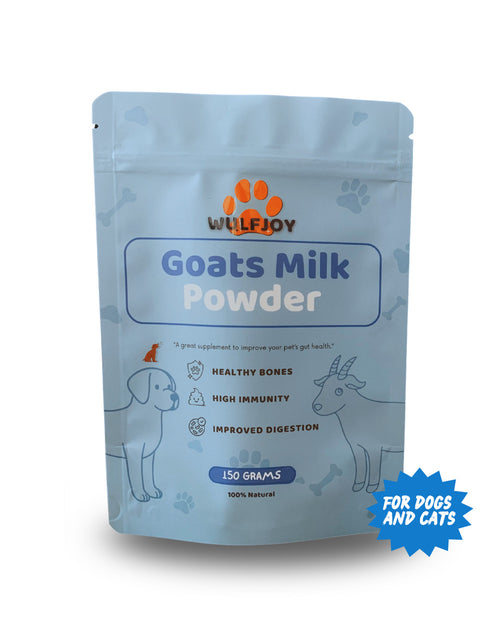 A light blue stand-up pouch of Wulfjoy Goats Milk Powder dog supplement, featuring illustrations of a dog and a goat, on a white background with a blue 'FOR DOGS AND CATS' badge.