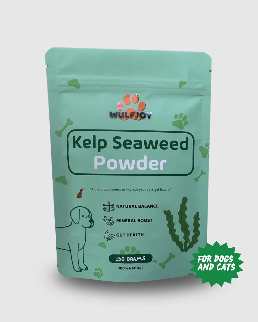 A stand-up pouch of Wulfjoy Kelp Seaweed Powder dog supplement, in a mint green color with illustrations of seaweed, bones, and a dog. A green starburst badge on the bottom right reads 'FOR DOGS AND CATS'.